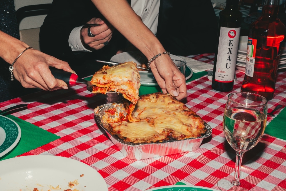 person serving lasagna